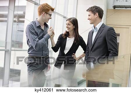 Business executives smiling in an office View Large Photo Image Stock Image - Business executives smiling in an office. Fotosearch