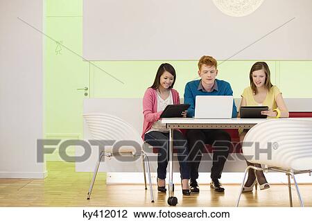 Business executives working in an office View Large Photo Image Stock Image - Business executives working in an office. Fotosearch