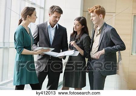 Stock Image - Business executives working in an office. Fotosearch