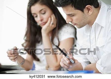 Business executives working in an office View Large Photo Image Stock Image - Business executives working in an office. Fotosearch