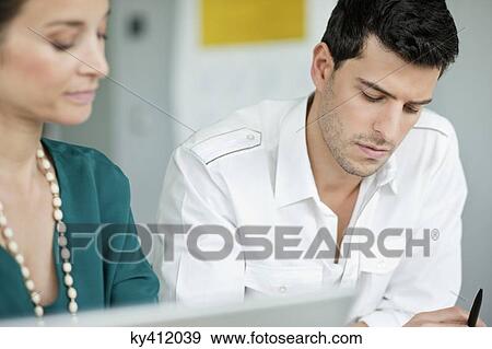 Business executives working in an office View Large Photo Image Stock Photo - Business executives working in an office. Fotosearch