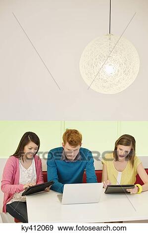 Stock Photo - Business executives working in an office. Fotosearch