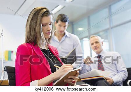 Stock Photograph - Business executives working in an office. Fotosearch