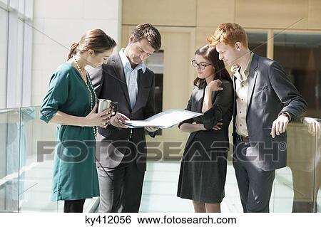 Stock Photograph - Business executives working in an office. Fotosearch