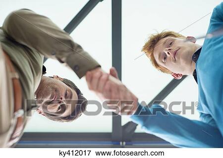 Businessmen shaking hands in an office View Large Photo Image Stock Photo - Businessmen shaking hands in an office. Fotosearch