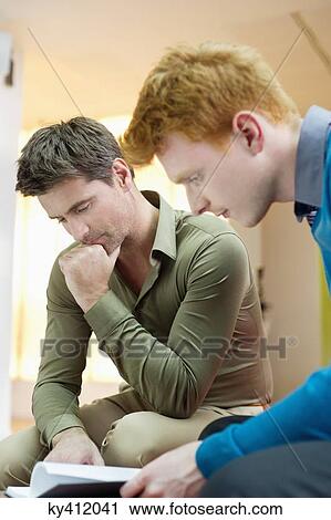 Stock Image - Businessmen working in an office. Fotosearch