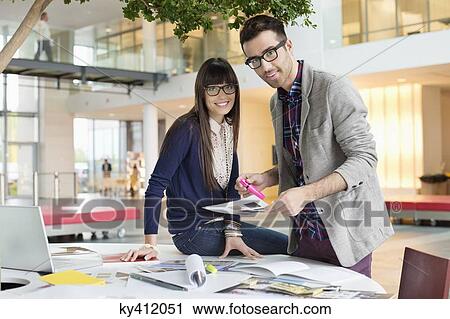 Stock Image - Portrait of architects working in an office. Fotosearch
