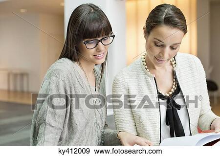 Two businesswomen discussing in an office View Large Photo Image Stock Photo - Two businesswomen discussing in an office. Fotosearch