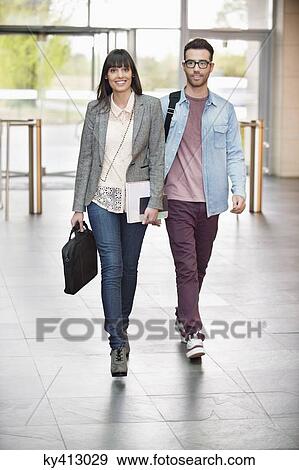 Business executives entering in an office lobby View Large Photo Image Stock Photo - Business executives entering in an office lobby. Fotosearch