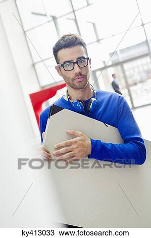 Design professional carrying a drawing board View Large Photo Image Stock Image - Design professional carrying a drawing board. Fotosearch
