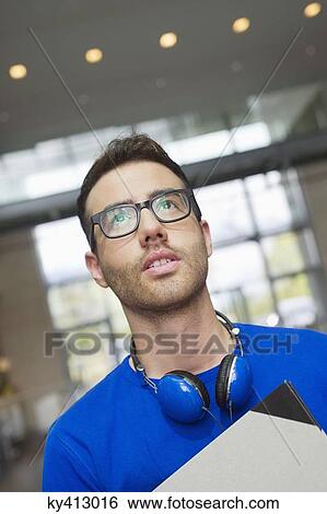 Design professional carrying a drawing board View Large Photo Image Stock Photograph - Design professional carrying a drawing board. Fotosearch