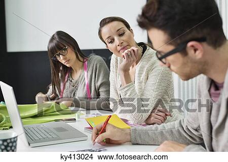 Fashion designers working in an office View Large Photo Image Picture - Fashion designers working in an office. Fotosearch