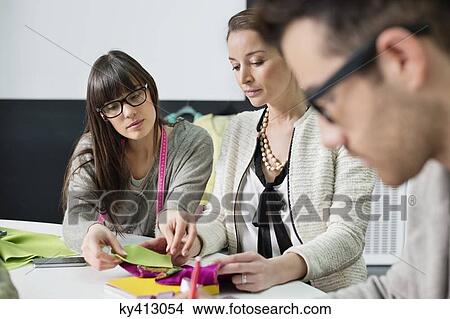 Fashion designers working in an office View Large Photo Image Picture - Fashion designers working in an office. Fotosearch