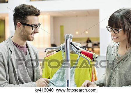 Stock Image - Fashion designers working in an office. Fotosearch