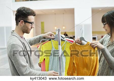 Stock Image - Fashion designers working in an office. Fotosearch