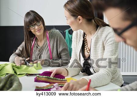 Stock Photo - Fashion designers working in an office. Fotosearch