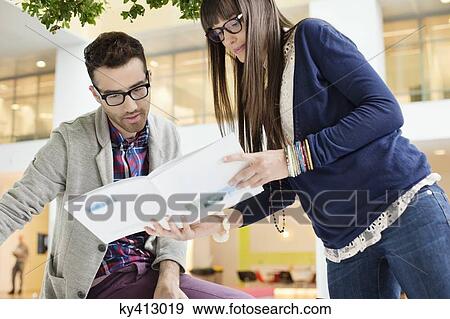 Stock Photo - Fashion designers working in an office. Fotosearch