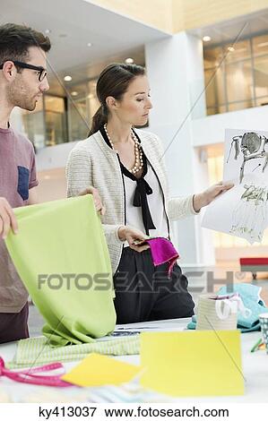 Stock Photo - Fashion designers working in an office. Fotosearch
