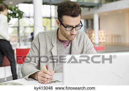 Stock Photo - Male fashion designer working in an office. Fotosearch