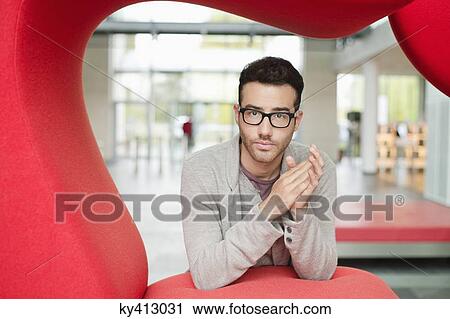 Stock Image - Portrait of a businessman thinking. Fotosearch