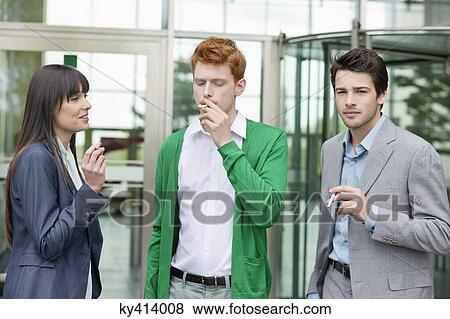 Business executives smoking in front of an office building View Large Photo Image Stock Photo - Business executives smoking in front of an office building. Fotosearch