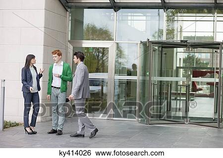 Stock Photograph - Business executives smoking in front of an office building. Fotosearch
