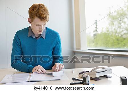 Businessman working in an office View Large Photo Image Stock Image - Businessman working in an office. Fotosearch
