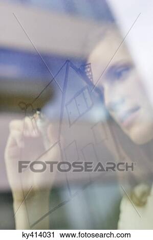 Businesswoman drawing a house on a glass surface View Large Photo Image Stock Image - Businesswoman drawing a house on a glass surface. Fotosearch