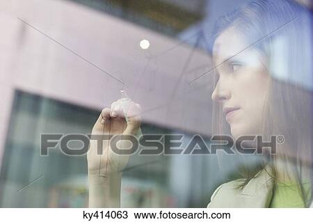 Businesswoman drawing a house on a glass surface View Large Photo Image Stock Image - Businesswoman drawing a house on a glass surface. Fotosearch