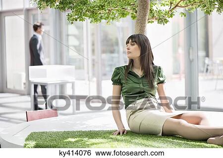 Businesswoman relaxing on grass mat View Large Photo Image Stock Photograph - Businesswoman relaxing on grass mat. Fotosearch