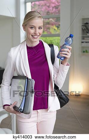 Stock Image - Businesswoman with files and water bottle. Fotosearch