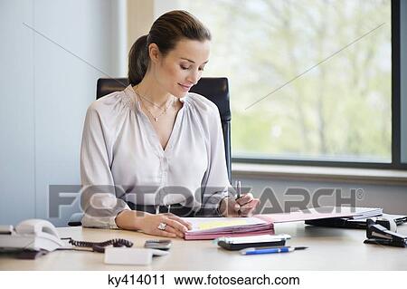 Businesswoman working in an office View Large Photo Image Stock Image - Businesswoman working in an office. Fotosearch