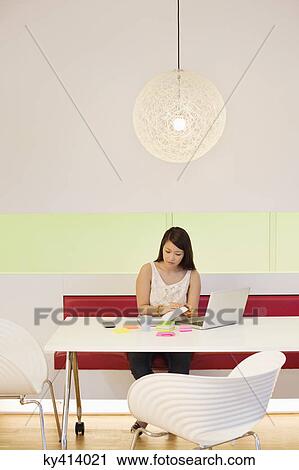 Businesswoman working in an office View Large Photo Image Stock Image - Businesswoman working in an office. Fotosearch