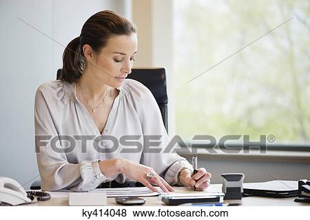 Stock Photo - Businesswoman working in an office. Fotosearch
