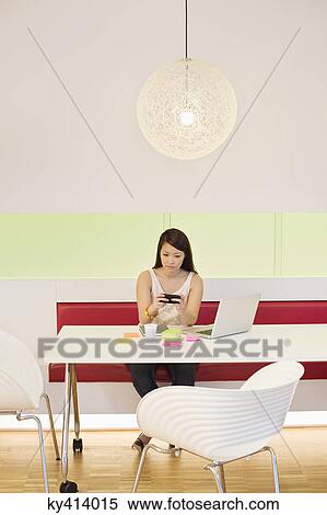 Businesswoman working in an office View Large Photo Image Stock Photography - Businesswoman working in an office. Fotosearch