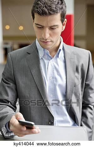 Close-up of a businessman text messaging View Large Photo Image Picture - Close-up of a businessman text messaging. Fotosearch