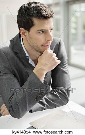 Close-up of a businessman thinking View Large Photo Image Picture - Close-up of a businessman thinking. Fotosearch