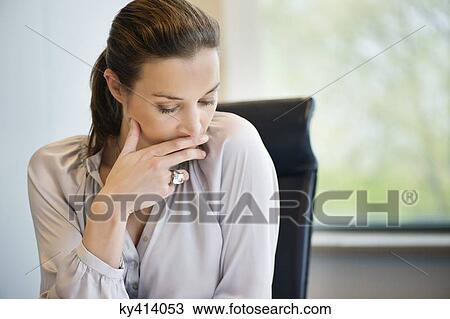 Stock Image - Close-up of a businesswoman thinking in an office. Fotosearch