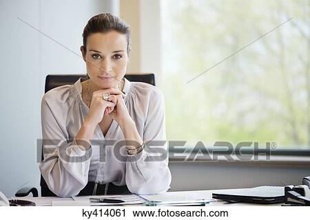 Portrait of a businesswoman in an office View Large Photo Image Stock Image - Portrait of a businesswoman in an office. Fotosearch
