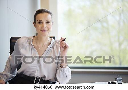 Portrait of a businesswoman smiling in an office View Large Photo Image Stock Photograph - Portrait of a businesswoman smiling in an office. Fotosearch