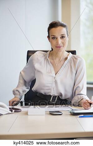 Stock Photography - Portrait of a businesswoman working in an office. Fotosearch