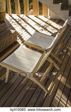Stock Image - High angle view of two chairs on a terrace. Fotosearch
