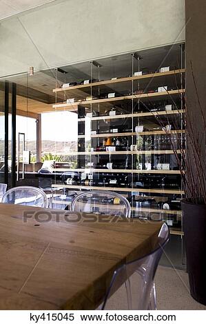 Stock Photography - Interiors of a room with wine rack in the background. Fotosearch