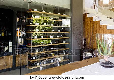 Stock Image - Interiors of a room with wine rack. Fotosearch