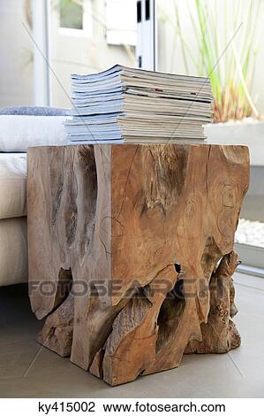 Stack of magazines on a table made from tree stump View Large Photo Image Stock Image - Stack of magazines on a table made from tree stump. Fotosearch