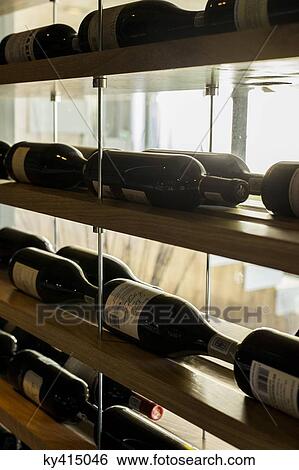Wine bottles in racks View Large Photo Image Stock Photograph - Wine bottles in racks. Fotosearch