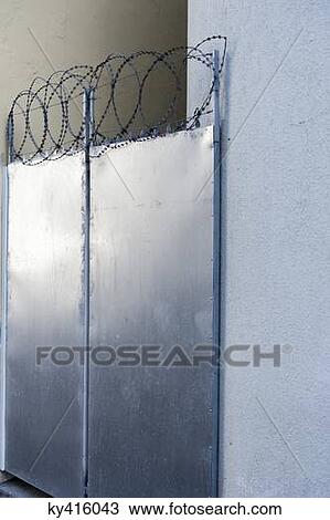 Closed door with razor wire View Large Photo Image Stock Image - Closed door with razor wire. Fotosearch