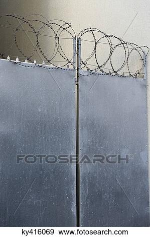 Closed door with razor wire View Large Photo Image Stock Photo - Closed door with razor wire. Fotosearch
