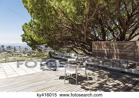 Empty chairs and table on roof View Large Photo Image Stock Photography - Empty chairs and table on roof. Fotosearch