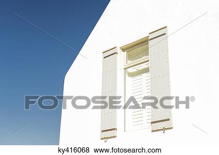 Stock Photo - Low angle view of a window with roller blinds. Fotosearch